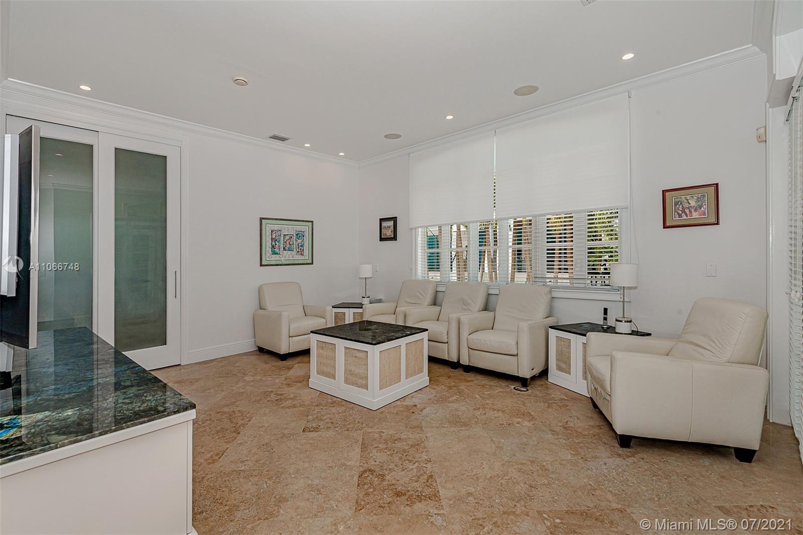 442 Woodcrest Road Key Biscayne, FL 33149 - Photo 9 of 48 a living room with furniture and a flat screen tv