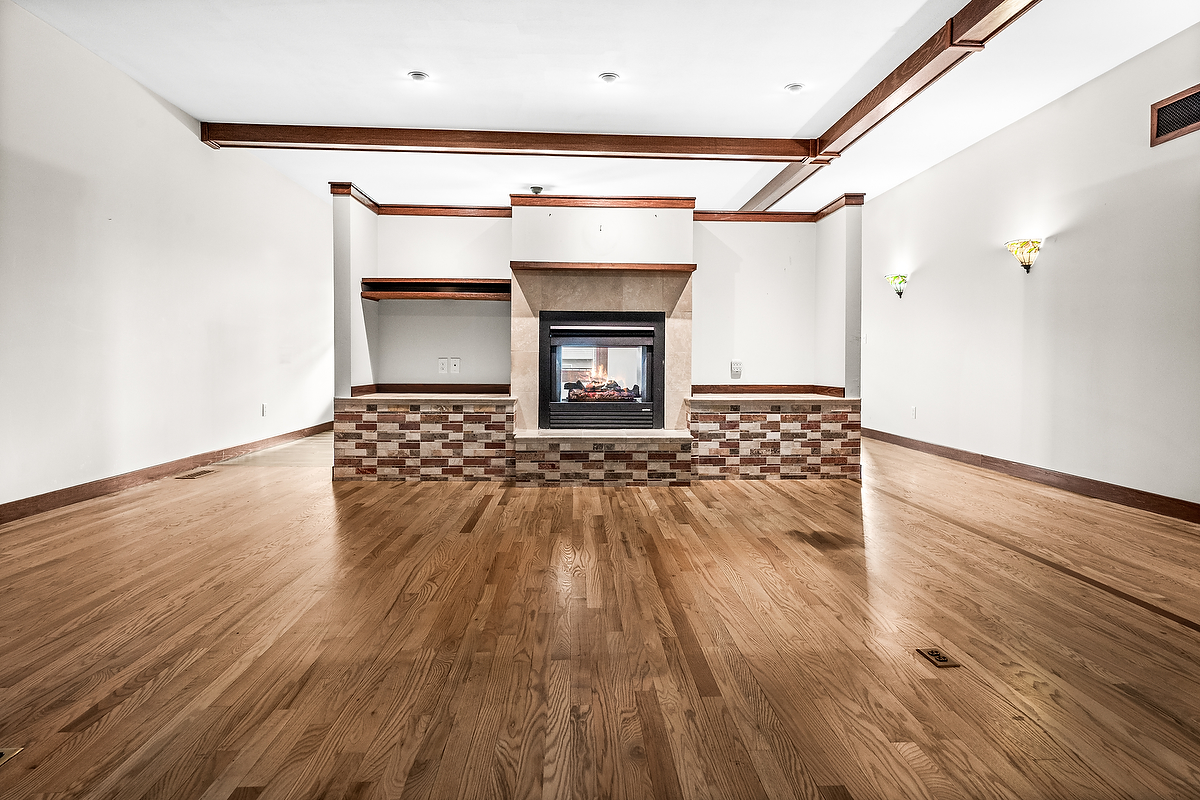 1515 Belclare Road Normal, IL 61761 - Photo 16 of 40 a empty room with wooden floor and fireplace