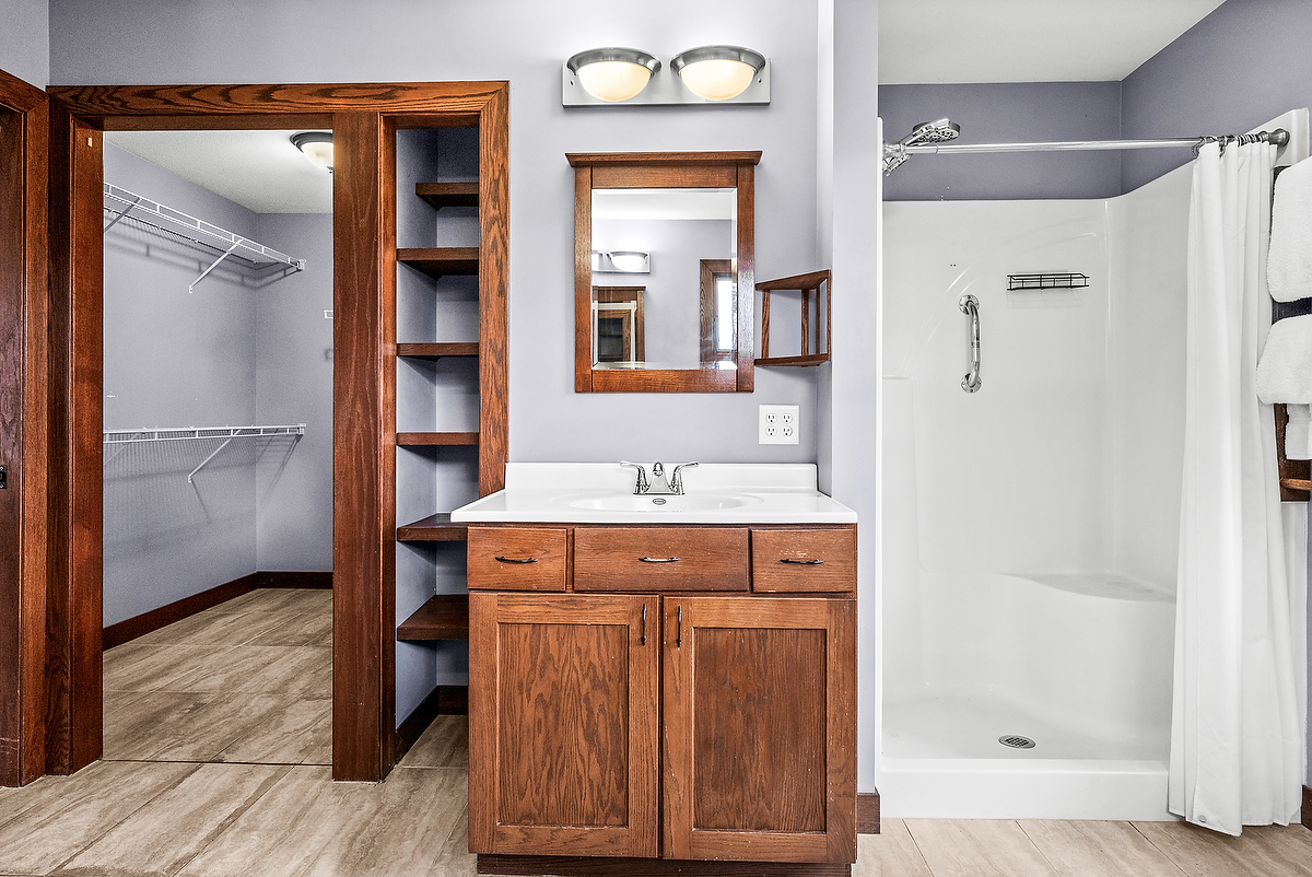 1515 Belclare Road Normal, IL 61761 - Photo 19 of 40 a bathroom with a granite countertop sink a mirror and a shower