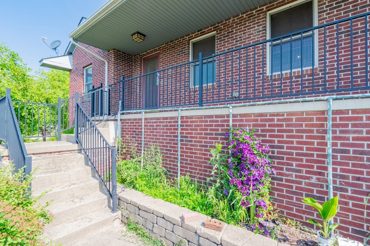 1515 Belclare Road Normal, IL 61761 - Photo 35 of 40 a view of a brick house with a flower garden