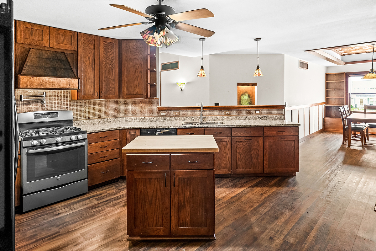 1515 Belclare Road Normal, IL 61761 - Photo 5 of 40 a kitchen with a stove cabinets and wooden floor