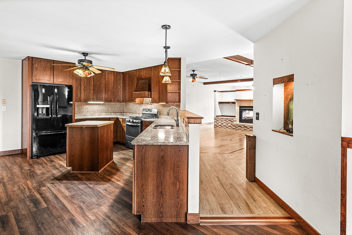 1515 Belclare Road Normal, IL 61761 - Photo 6 of 40 a kitchen view with granite countertop a stove and refrigerator