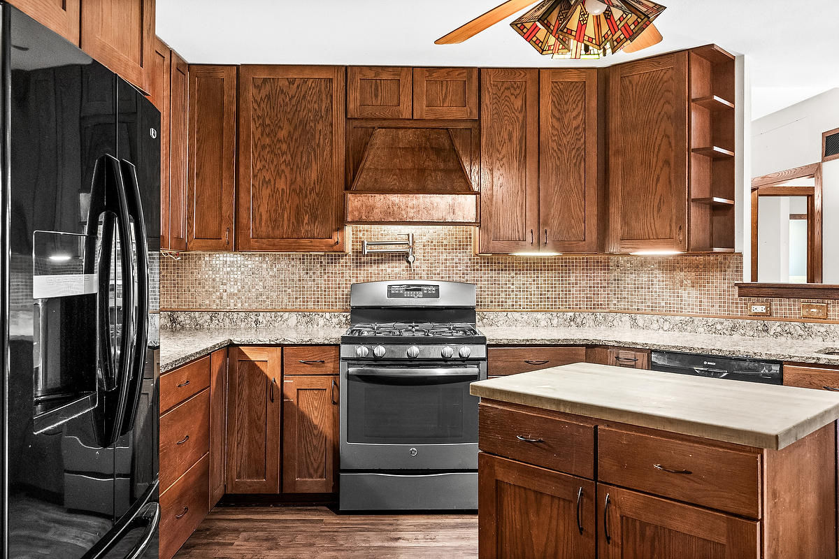 1515 Belclare Road Normal, IL 61761 - Photo 8 of 40 a kitchen with a sink stove and refrigerator