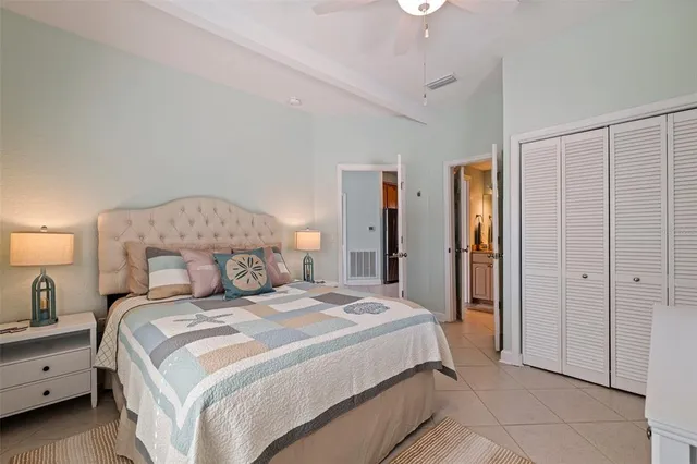 a bedroom with a bed and a lamp