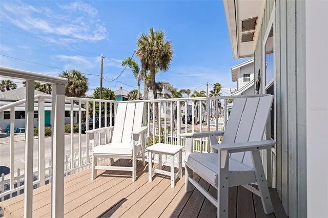 a view of a balcony with two chairs and a table