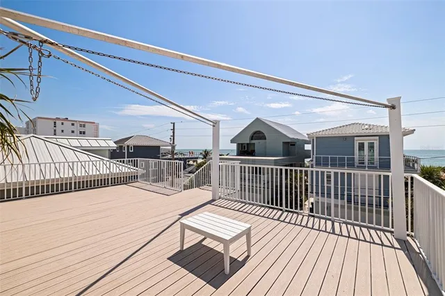 a view of balcony with furniture and potted plants