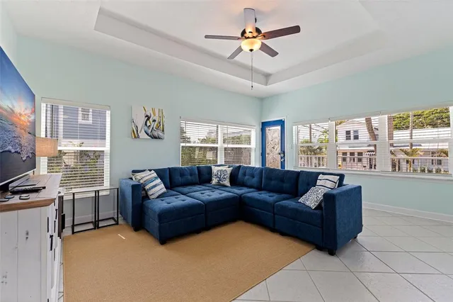 a living room with furniture ceiling fan and a window