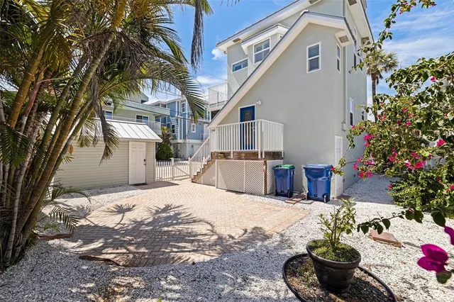 an aerial view of a house with balcony and outdoor seating