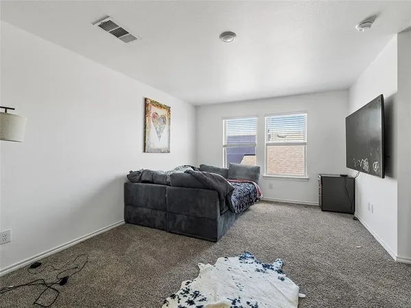 a living room with a bed furniture and a flat screen tv
