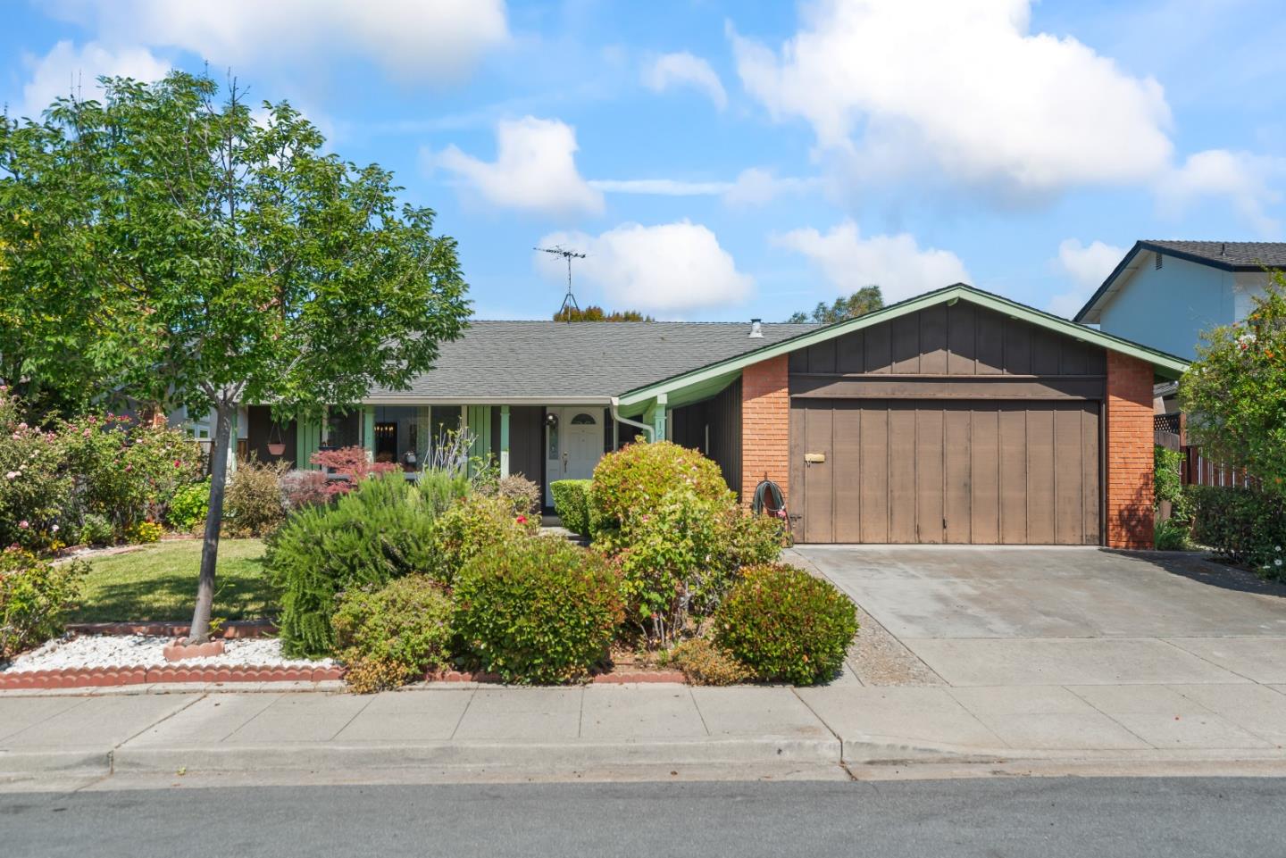 a front view of a house with a garden