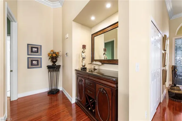 a view of a hallway view with wooden floor and staircase