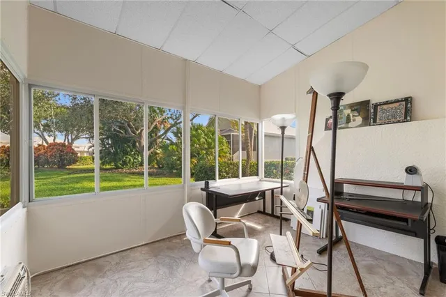 a living room with furniture and a floor to ceiling window