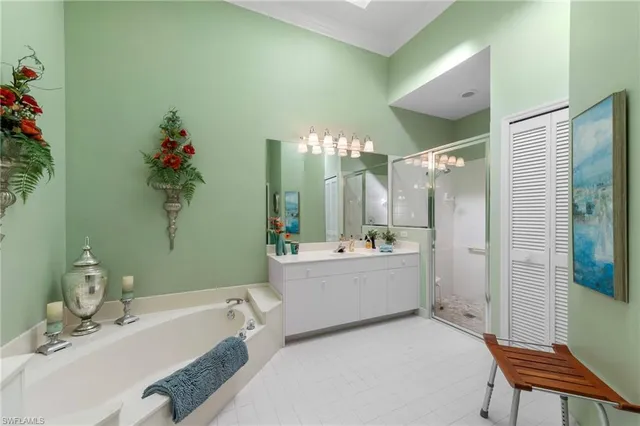 a bathroom with a tub sink and mirror