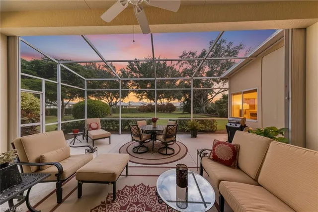 a outdoor space with patio the couches and pool table and chairs under an umbrella