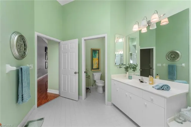 a spacious bathroom with a double vanity sink and a mirror