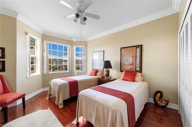 a bedroom with two beds and a window