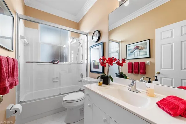 a bathroom with a sink vanity mirror and toilet