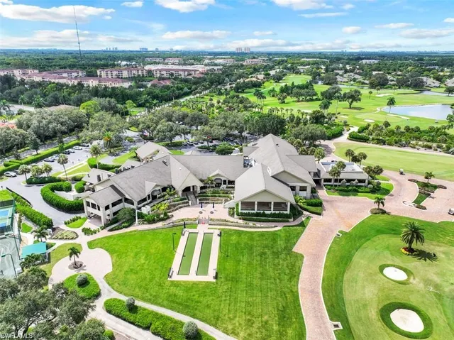 an aerial view of residential houses with outdoor space and swimming pool