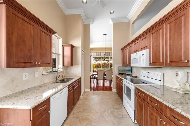 a large kitchen with stainless steel appliances granite countertop a sink stove and refrigerator