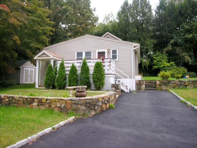 36 Bancroft Road Newtown, CT 06482 - Photo 1 of 1 a front view of a house with a yard