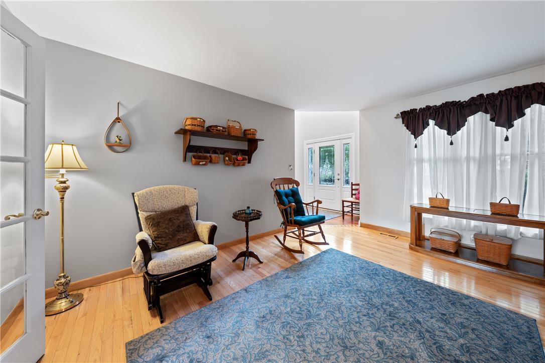 4568 Greenfield Road Bethlehem, PA 18017 - Photo 9 of 59 Hardwood floors complement this bright living area, offering a warm and inviting atmosphere.