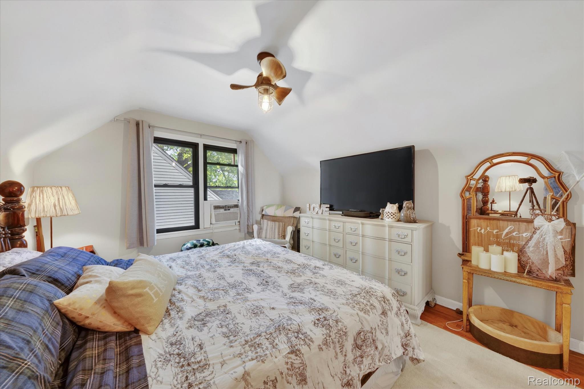 22729 Cleveland Street Dearborn, MI 48124 - Photo 17 of 32 Bedroom featuring sloped ceilings, a window with dark trim, wood-finish flooring, and a ceiling fan with integrated lighting
