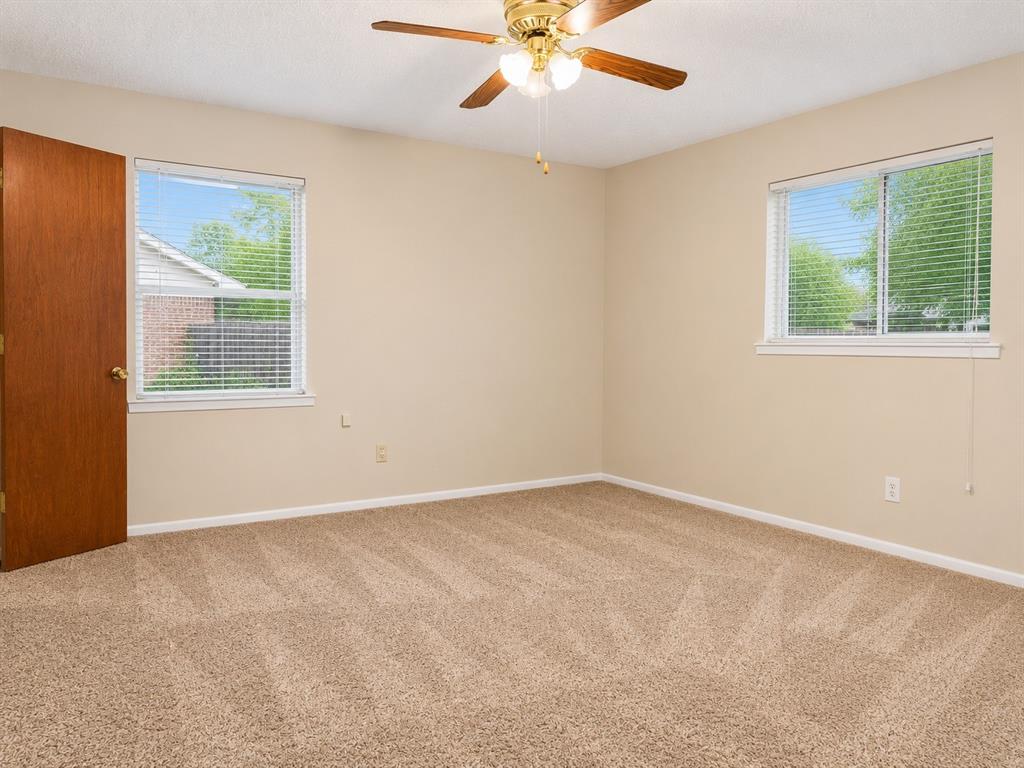 2111 Quail Run, Unit A McKinney, TX 75071 - Photo 9 of 12 an empty room with a window