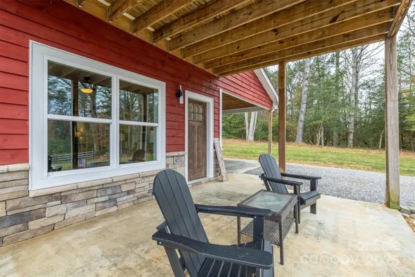 a view of a porch with chairs and backyard