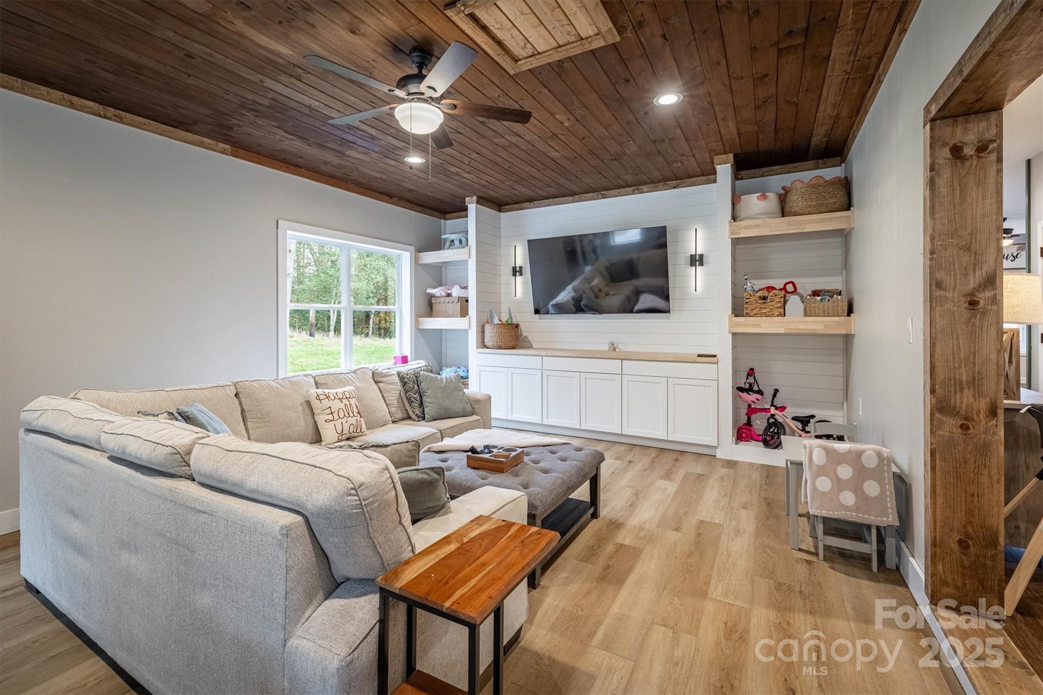4447 Steeltown Road Lenoir, NC 28645 - Photo 26 of 42 a living room with furniture and a flat screen tv