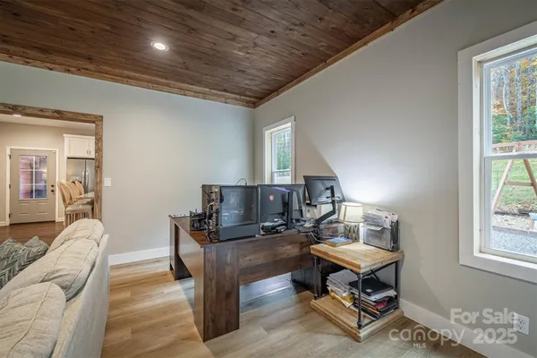 a living room with furniture a piano and a window