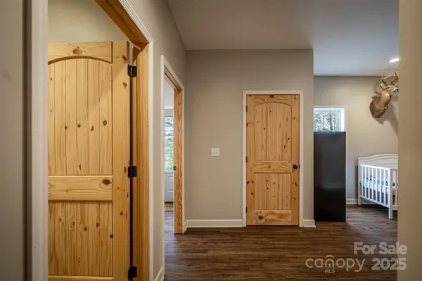 a view of a hallway with wooden floor