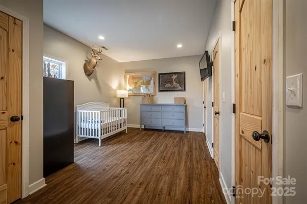 a view of a livingroom with wooden floor and furniture