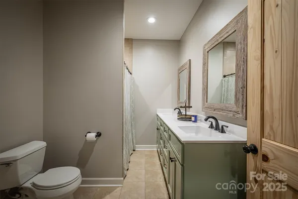 a bathroom with a sink toilet and mirror