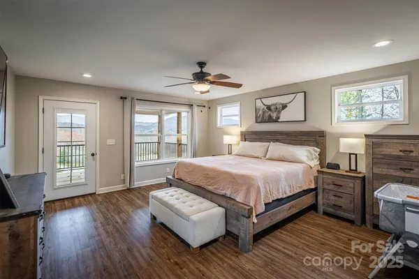 a spacious bedroom with a bed and a large window
