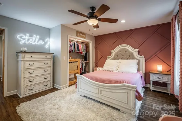 a spacious bedroom with a bed and a dresser