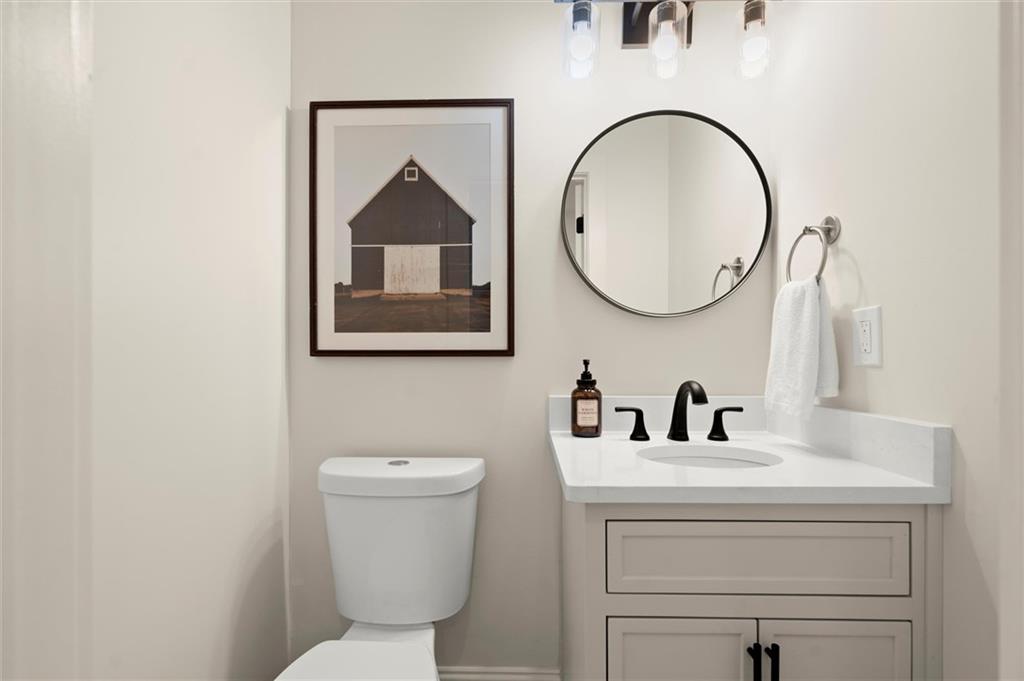539 Schofield Drive Powder Springs, GA 30127 - Photo 15 of 41 a bathroom with a toilet a sink and mirror