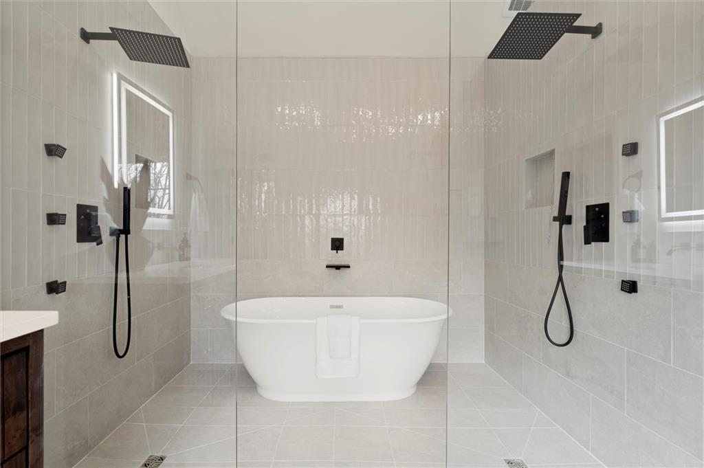 539 Schofield Drive Powder Springs, GA 30127 - Photo 18 of 41 a bathroom with a bathtub and shower