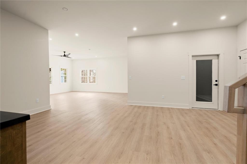 539 Schofield Drive Powder Springs, GA 30127 - Photo 31 of 41 an empty room with wooden floor and windows