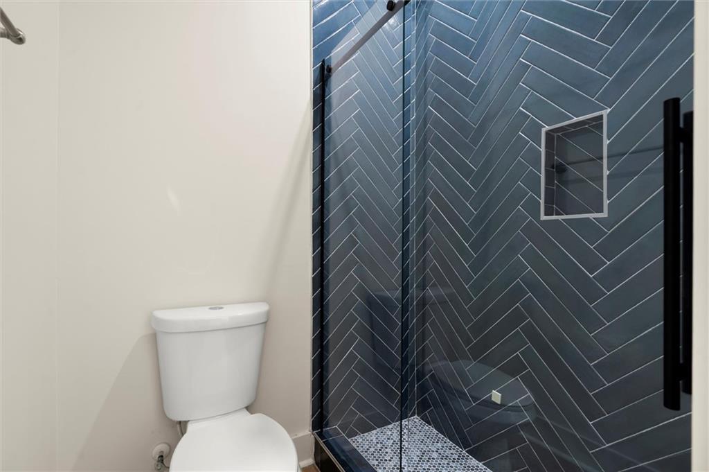 539 Schofield Drive Powder Springs, GA 30127 - Photo 35 of 41 a white toilet sitting next to a shower