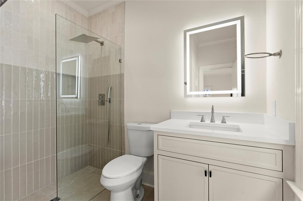 539 Schofield Drive Powder Springs, GA 30127 - Photo 39 of 41 a bathroom with a toilet sink vanity granite and shower
