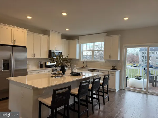 a kitchen with counter space dining table and stainless steel appliances