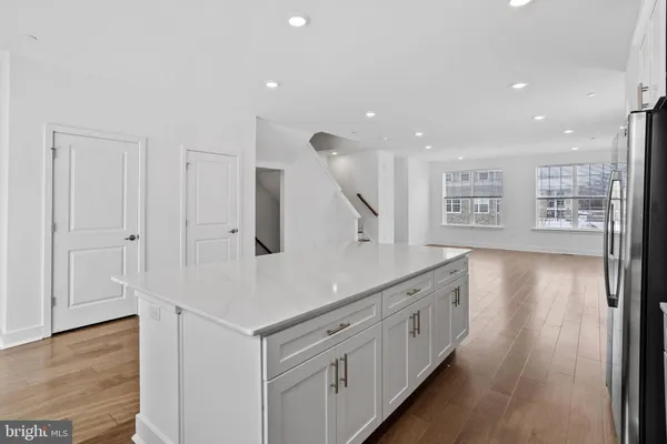 a kitchen with stainless steel appliances granite countertop a stove and a wooden floors