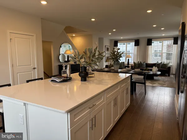 a kitchen with kitchen island a sink appliances and a counter top space