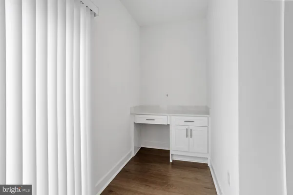 a view of a kitchen with white cabinets