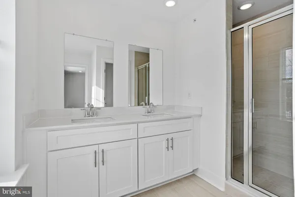 a bathroom with double sink and a mirror