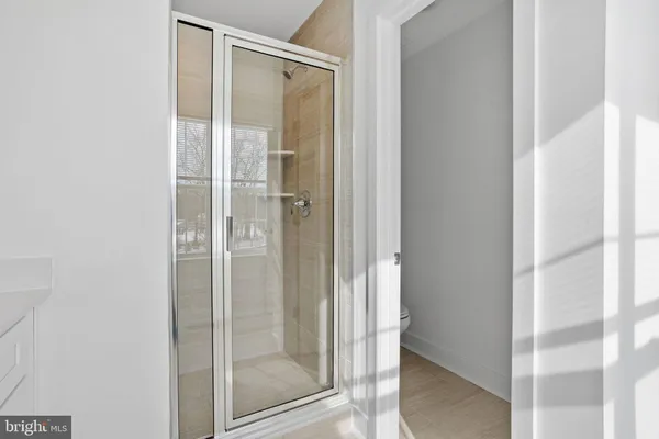 a bathroom with a glass shower door