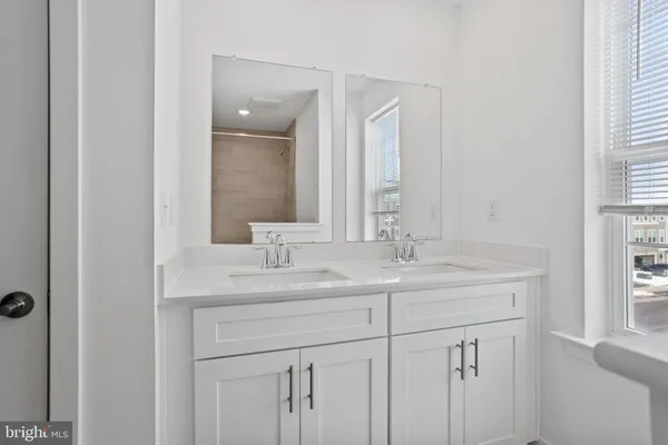 a bathroom with 2 sink and a mirror
