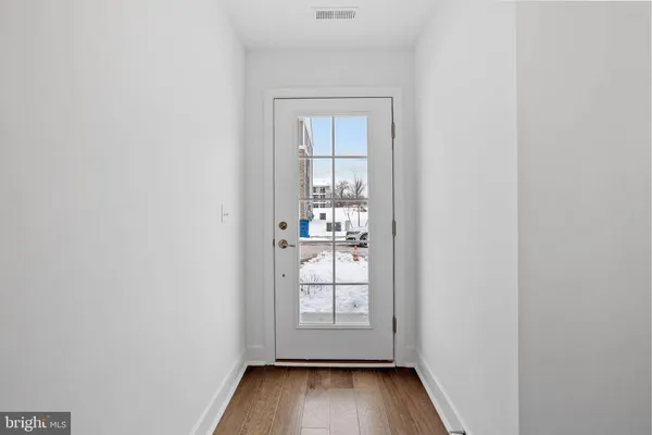 a view of wooden floor and a window in a room