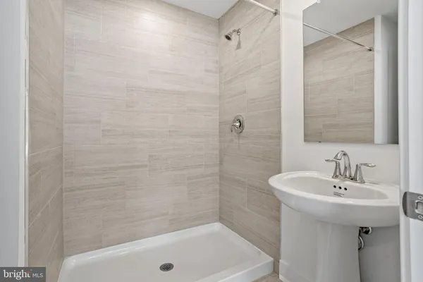 a bathroom with a sink a mirror and a bathtub