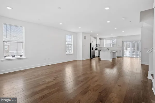 a view of kitchen with cabinets and wooden floor